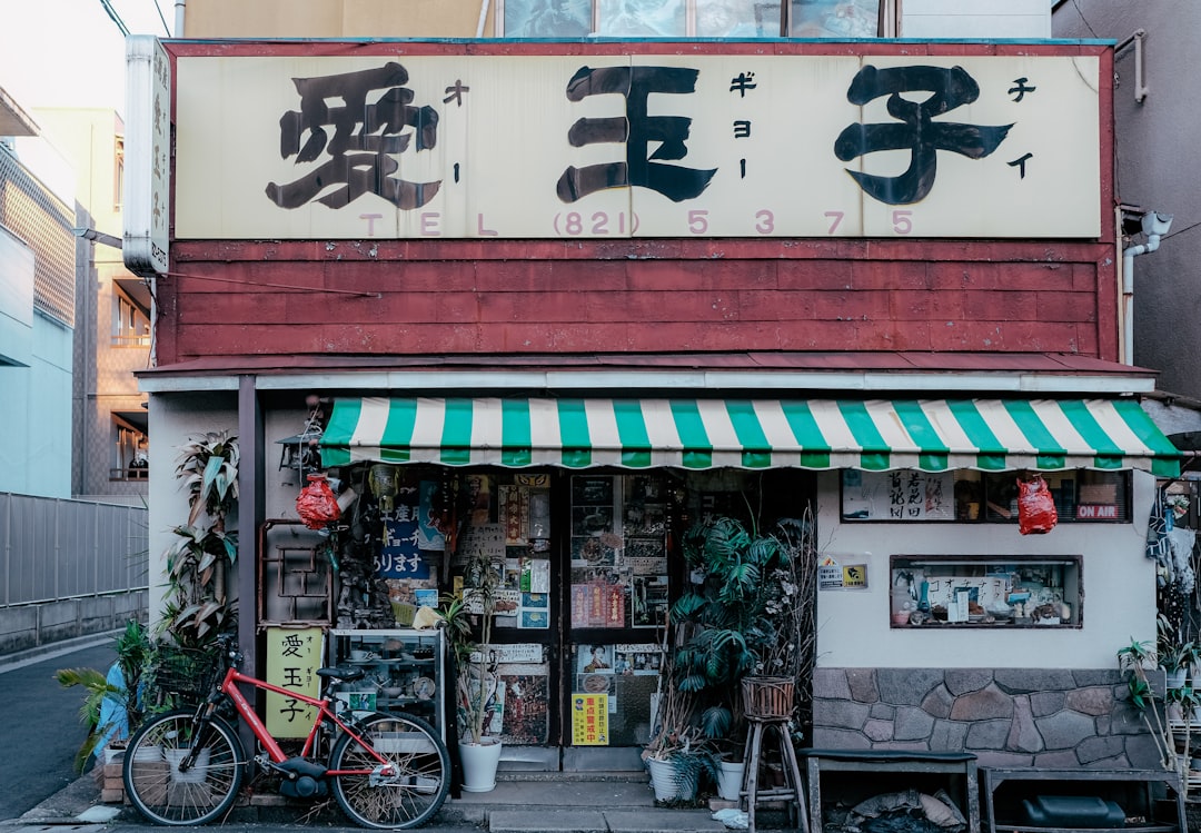 a store front with a bicycle parked outside of it