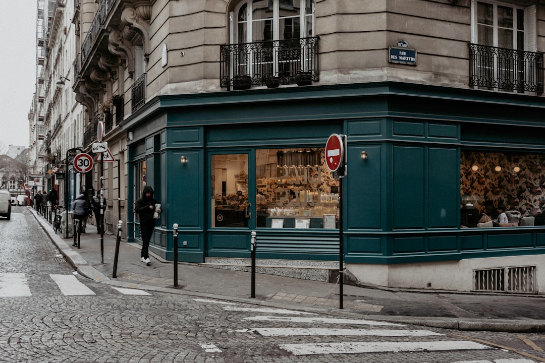 people walking on sidewalk near store during daytime