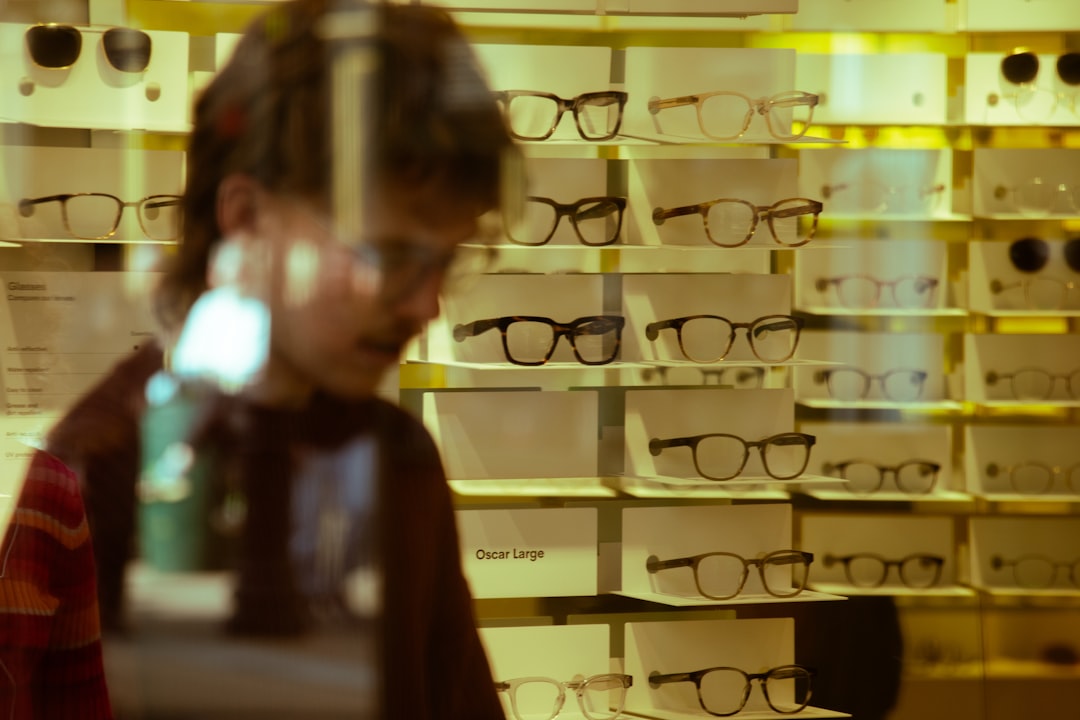 A person looking at glasses in a store display