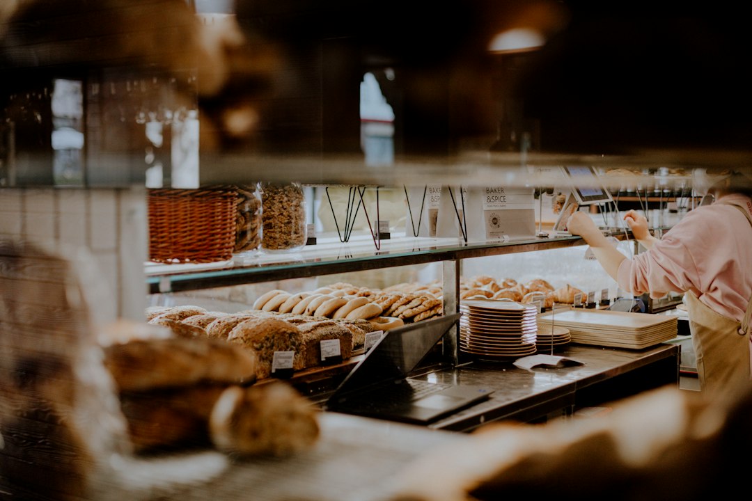 a woman working in a bakery behind a counter
