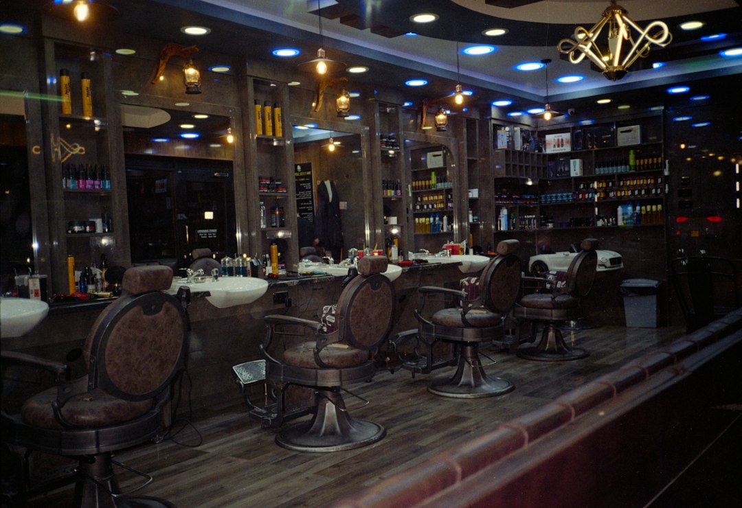 An empty barbershop interior with several chairs and mirrors